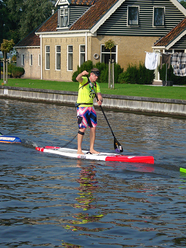 Frank Hettinga, specialist in Stand Up Paddling, peddelt door Heeg, zijn woonplaats. 